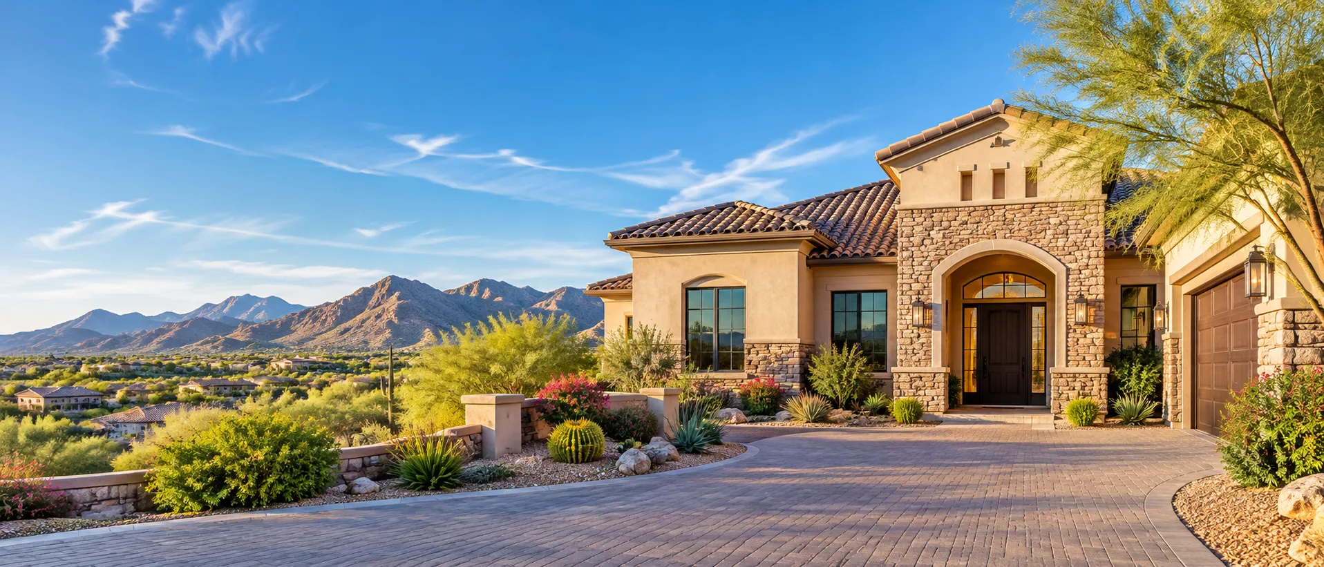 Desert-style home with a stone entry and mountain views